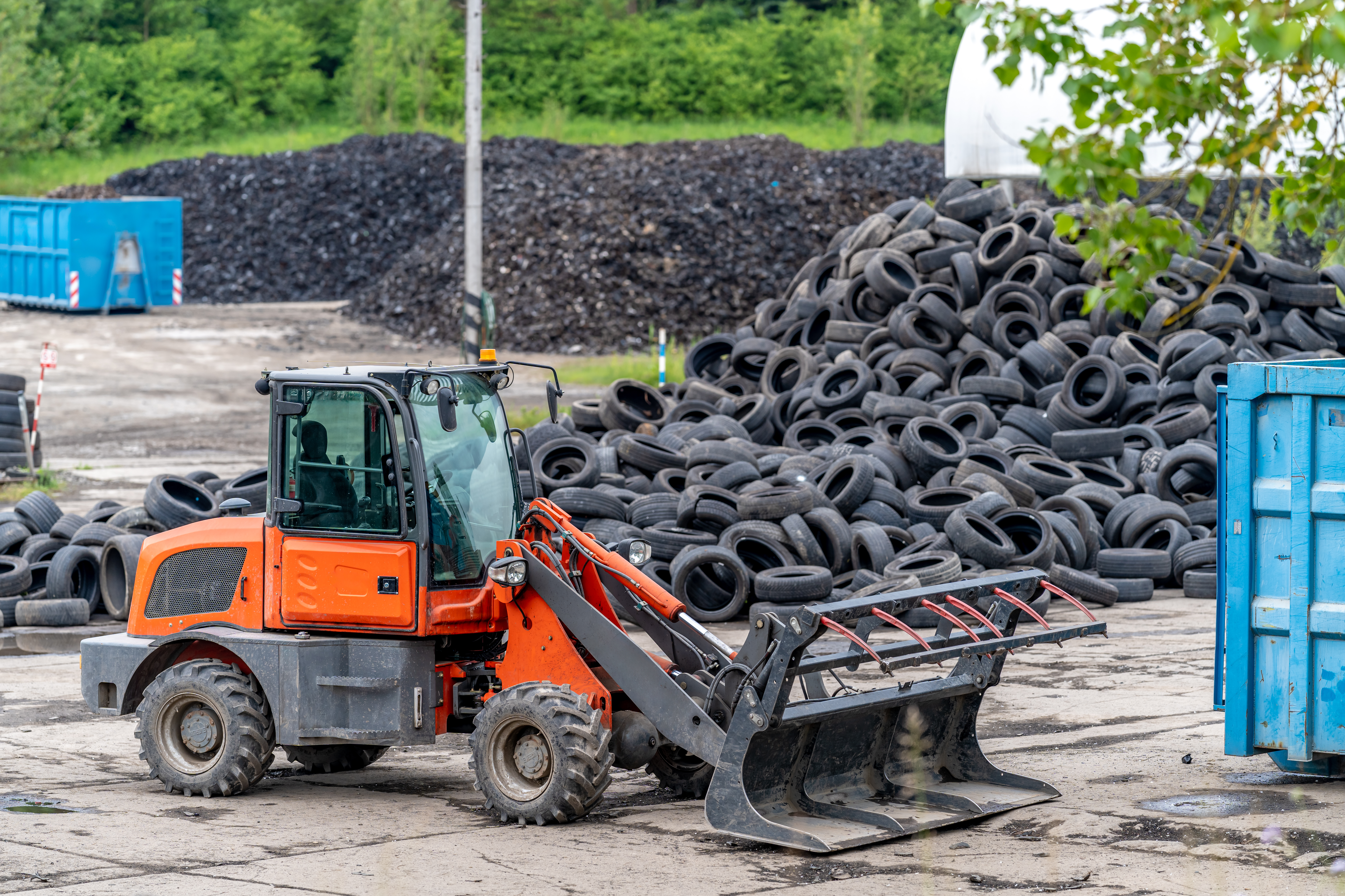 recycling and processing of old tires, loader in stock of used tires